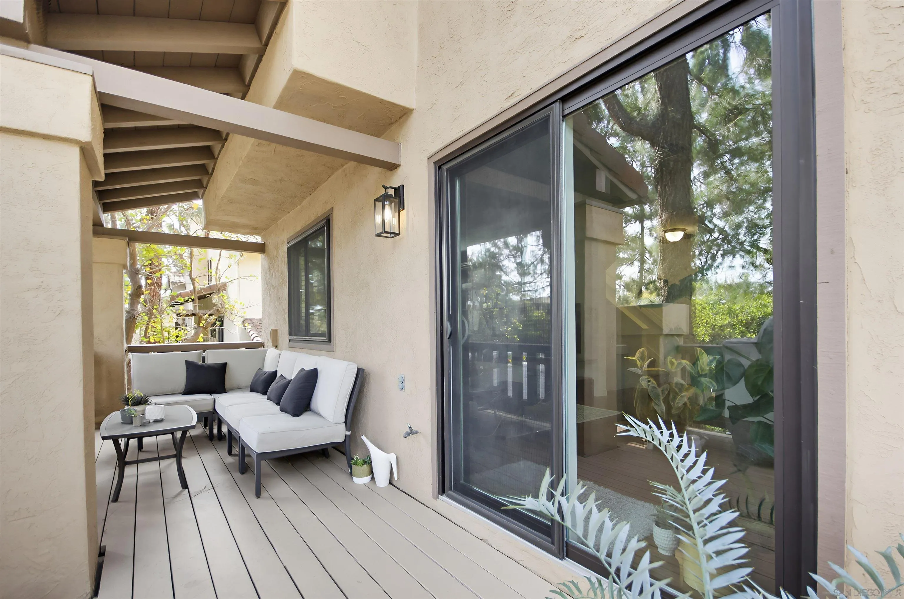 5822 Mission Center Road, Unit A San Diego, CA 92108 - Photo 16 of 35 a balcony with furniture and wooden floor