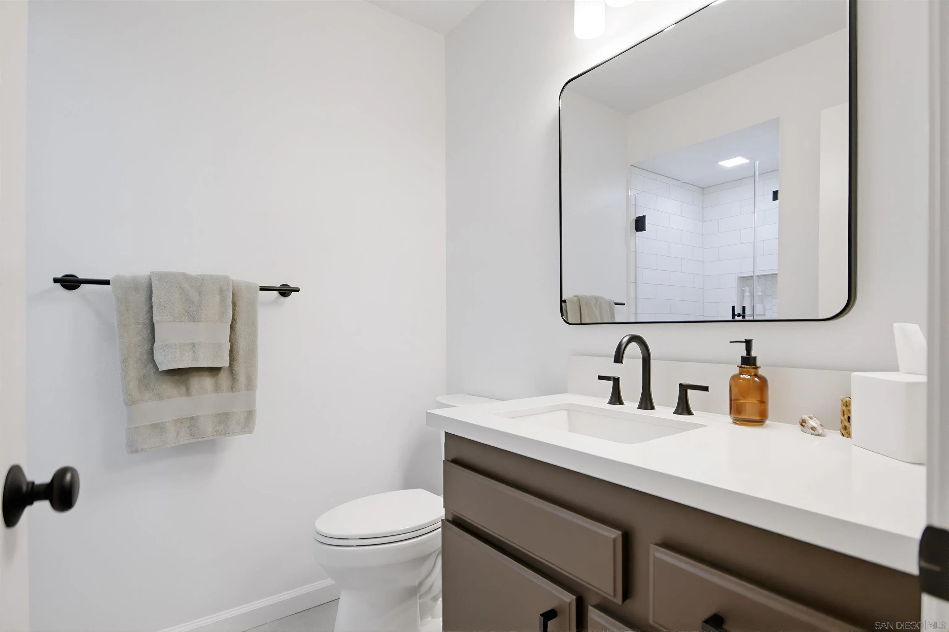 5822 Mission Center Road, Unit A San Diego, CA 92108 - Photo 19 of 35 a bathroom with a sink a toilet and mirror