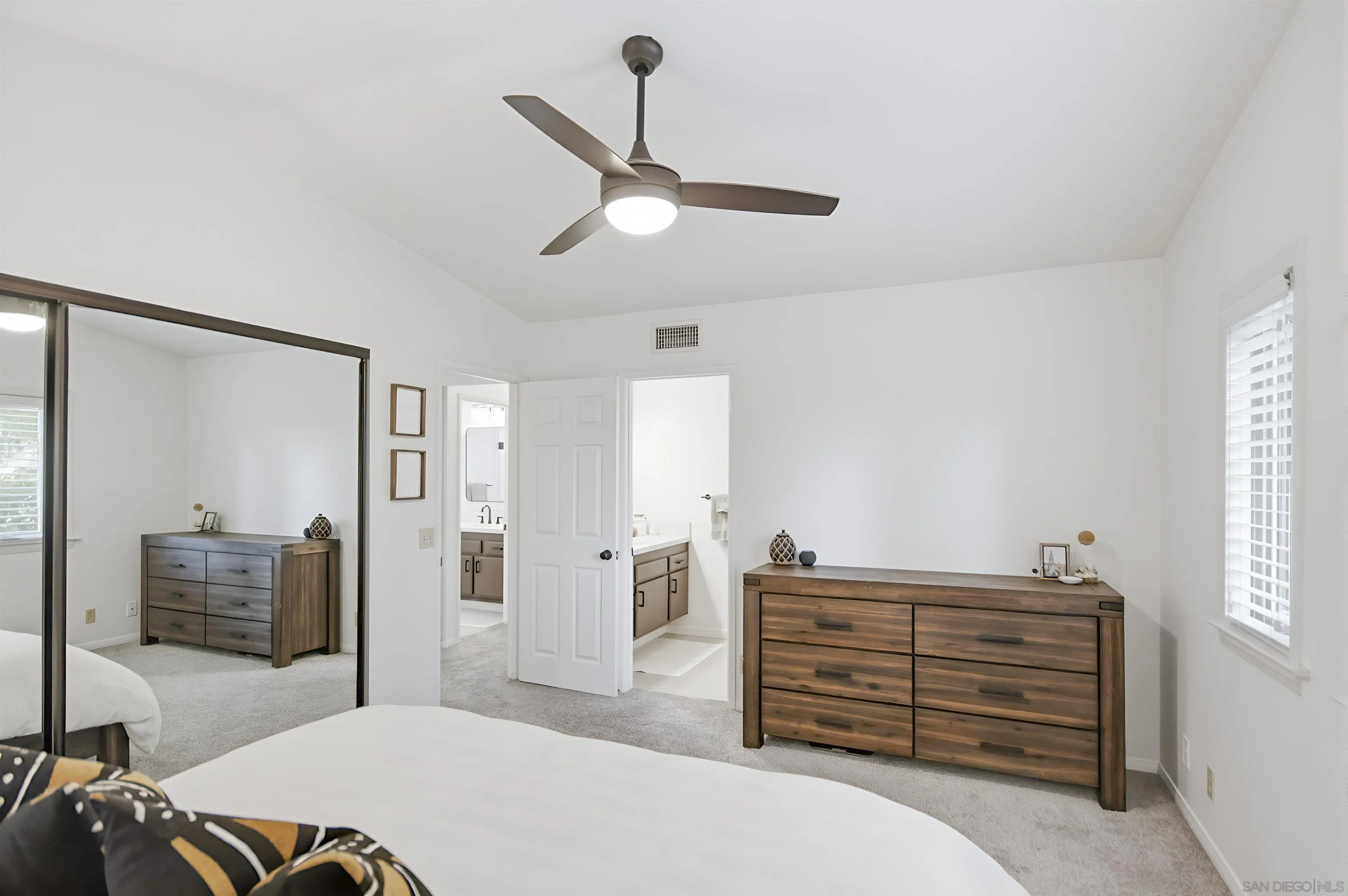 5822 Mission Center Road, Unit A San Diego, CA 92108 - Photo 27 of 35 a bedroom with a bed and wooden floor