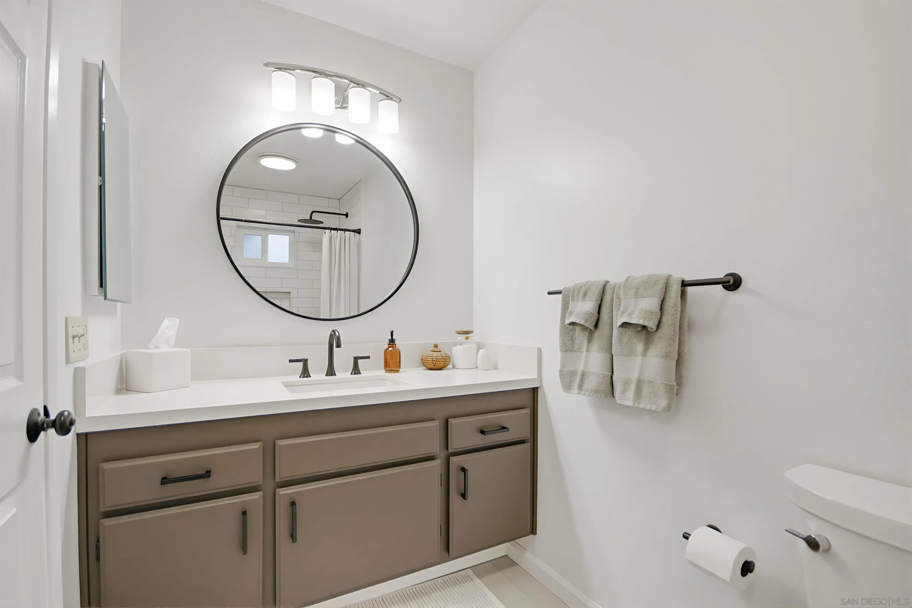 5822 Mission Center Road, Unit A San Diego, CA 92108 - Photo 29 of 35 a bathroom with a sink mirror and a toilet