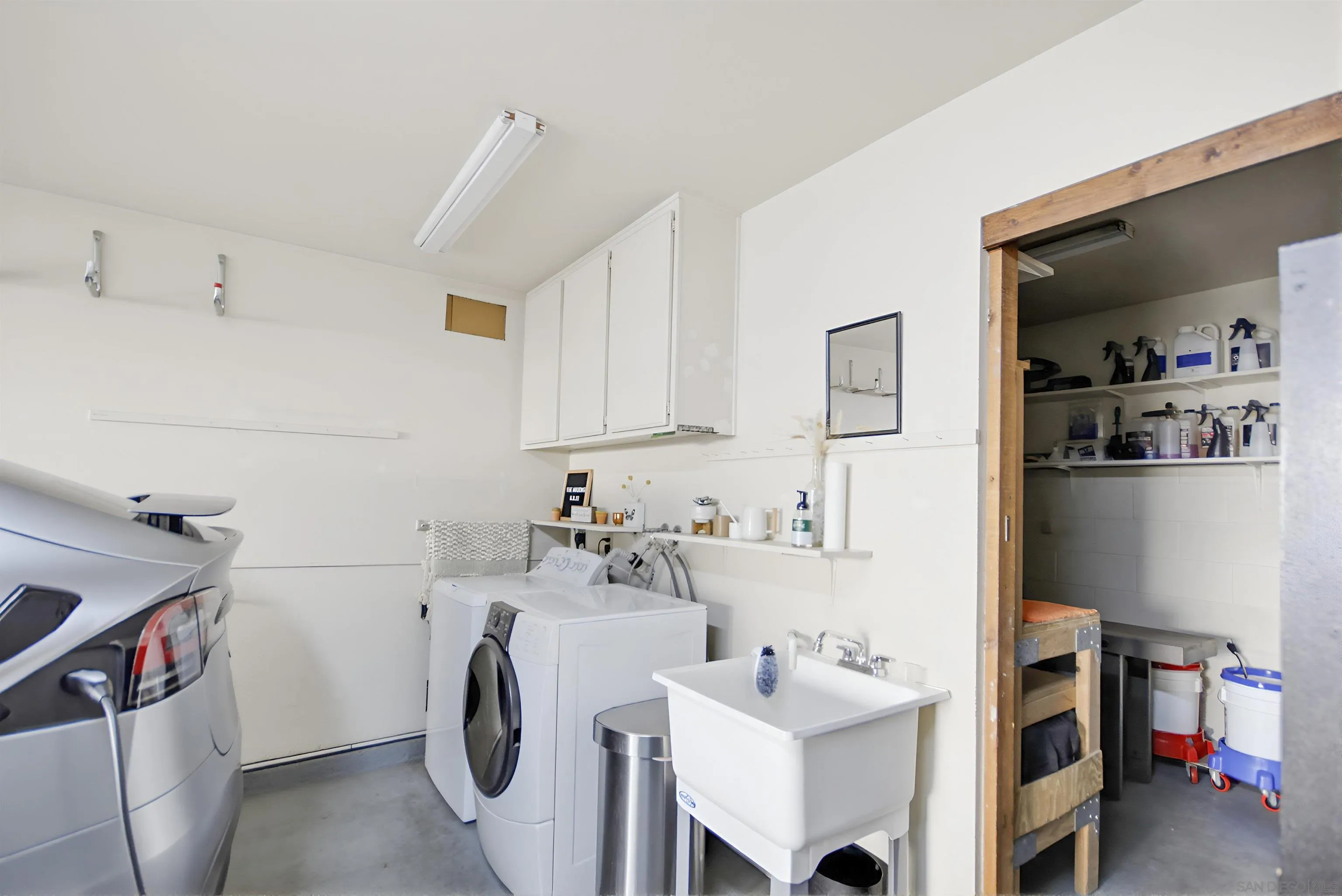 5822 Mission Center Road, Unit A San Diego, CA 92108 - Photo 31 of 35 a utility room with cabinets dryer and washer