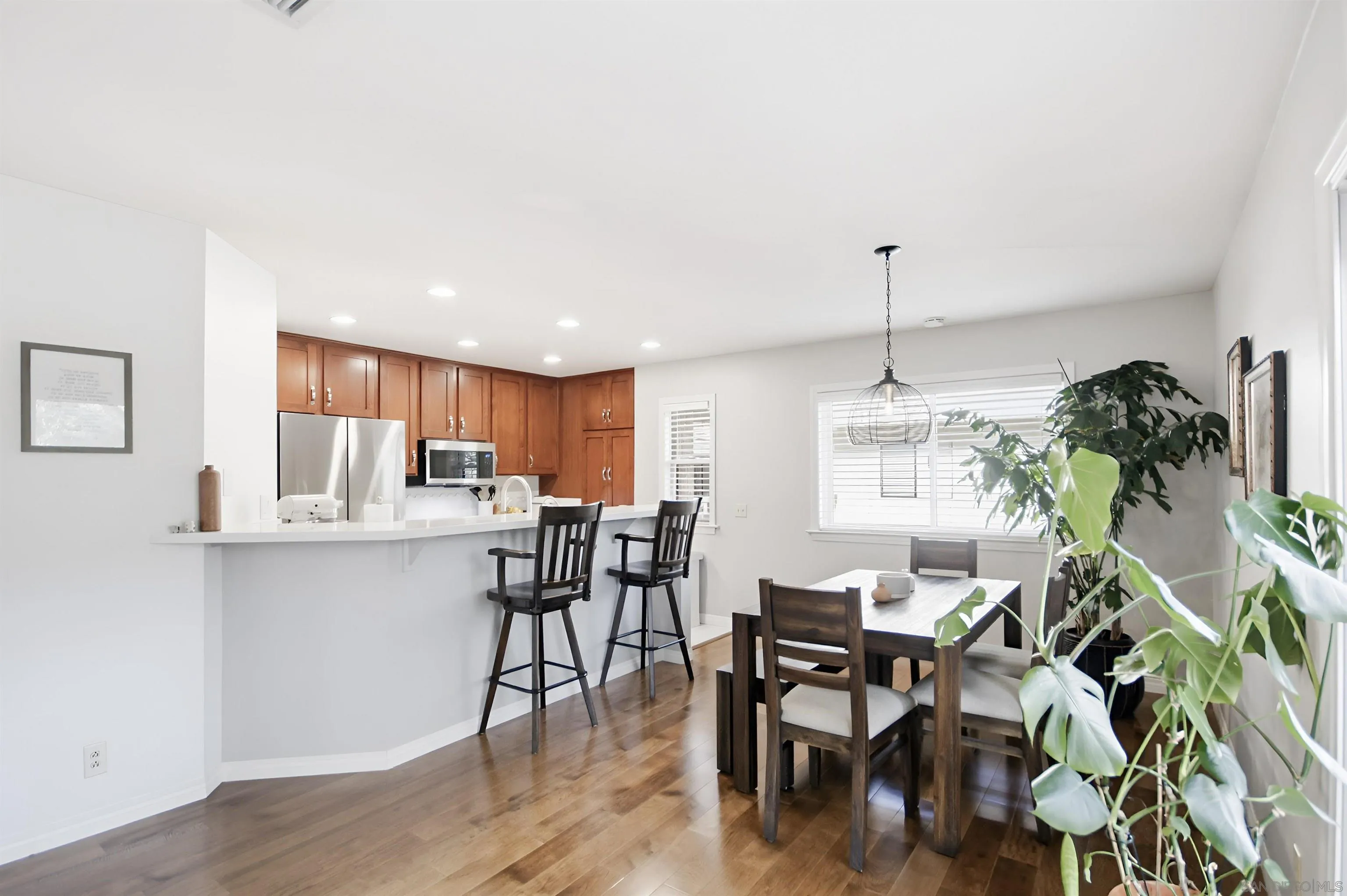 5822 Mission Center Road, Unit A San Diego, CA 92108 - Photo 5 of 35 a view of a dining room with furniture and wooden floor