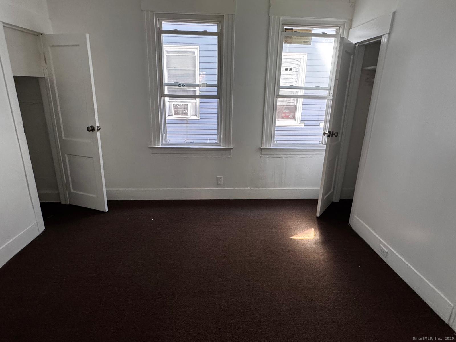 42 Bassett Street New Haven, CT 06511 - Photo 3 of 9 an empty room with wooden floor and windows