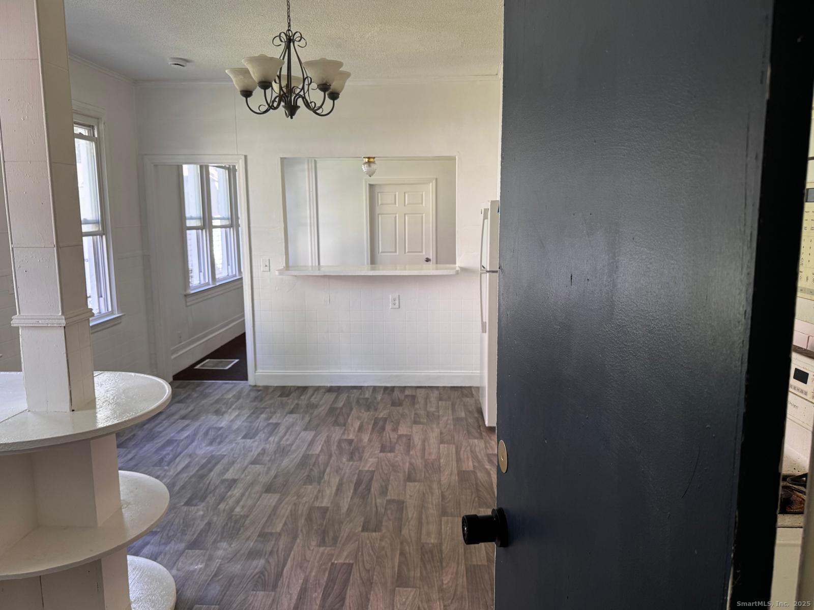 42 Bassett Street New Haven, CT 06511 - Photo 4 of 9 a view of empty room with wooden floor and fan