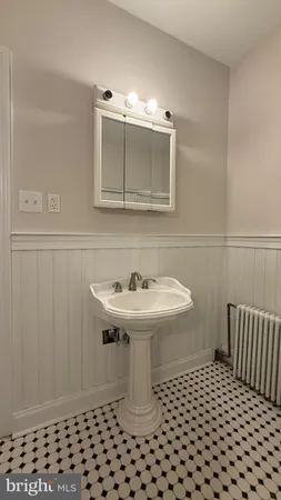 a bathroom with a sink a toilet and mirror