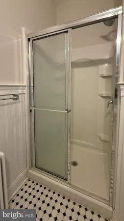 a bathroom with a glass door shower