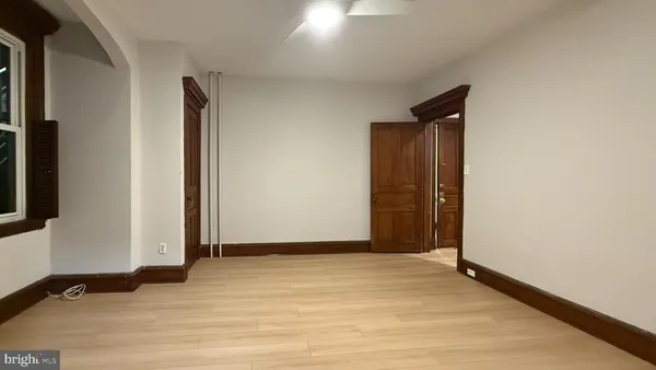 an empty room with wooden floor and closet