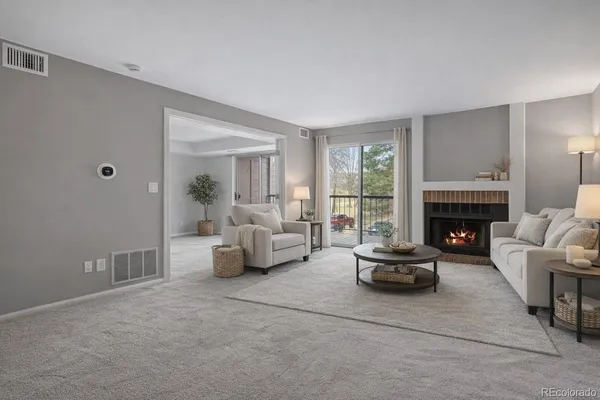 a living room with furniture and a fireplace
