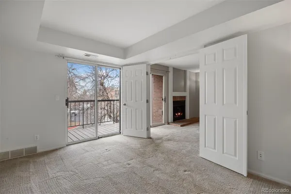 an empty room with windows and closet