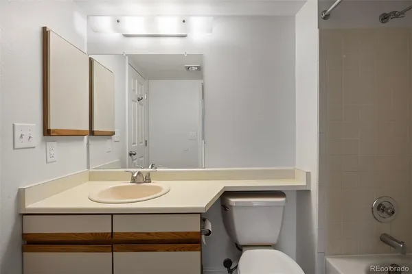 a bathroom with a sink toilet and a mirror