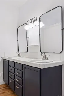a bathroom with a double vanity sink and a mirror