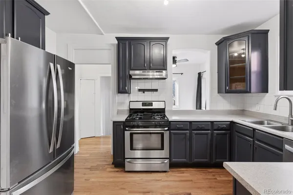 a kitchen with a stove and a refrigerator