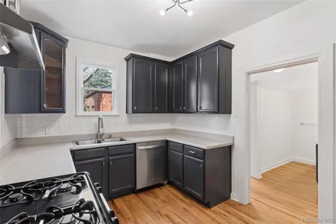 a kitchen with a sink and a stove top oven