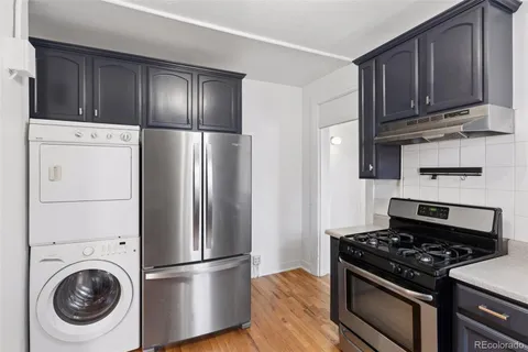 a kitchen with a stove and a refrigerator