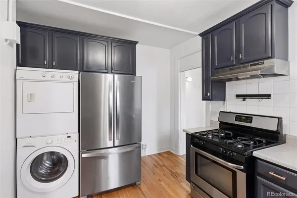 a kitchen with a stove and a refrigerator