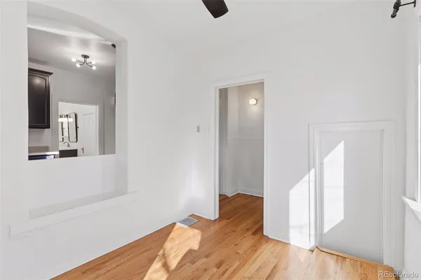 a view of a bedroom with wooden floor and bathroom