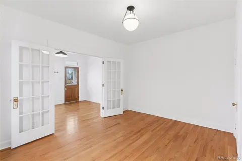 a view of empty room with wooden floor