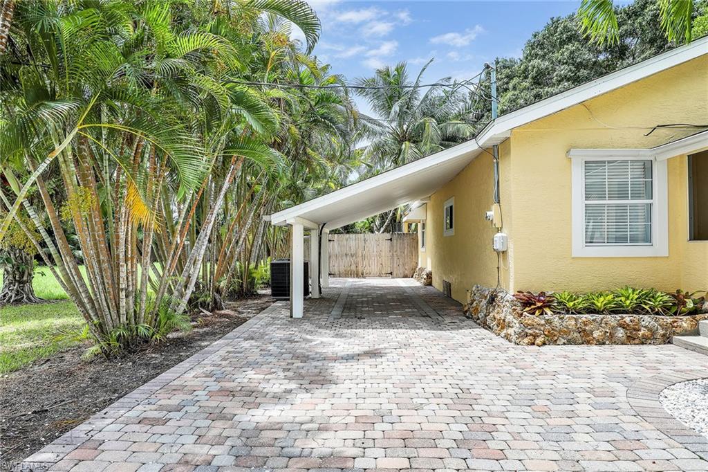 2780 Weeks Avenue Naples, FL 34112 - Photo 29 of 34 a front view of a house with garden