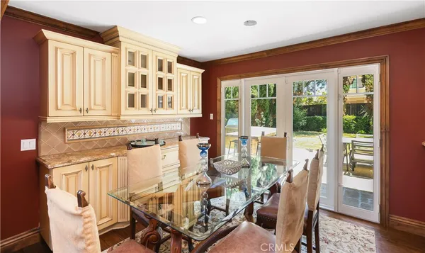 a view of a dining room with furniture large windows and wooden floor