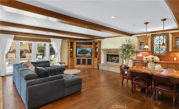 a living room with furniture a fireplace and a dining table