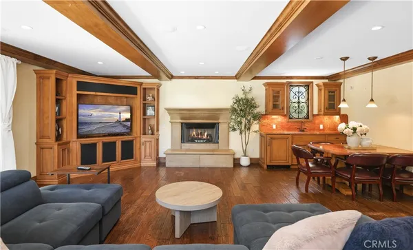 a living room with furniture a fireplace and wooden floor