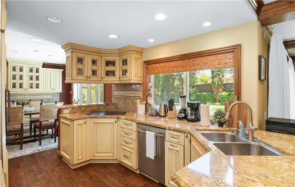 a kitchen with stainless steel appliances granite countertop a stove and a sink