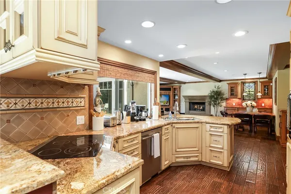 a kitchen with a sink appliances and cabinets