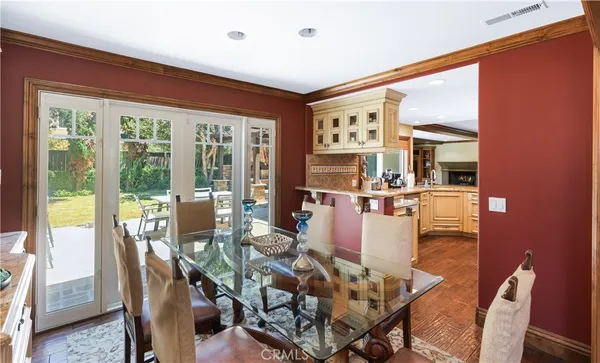 a dining room with furniture water view and large windows