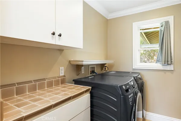 a kitchen with a sink a stove and cabinets