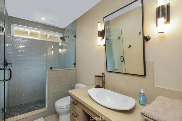 a bathroom with a toilet a sink and shower