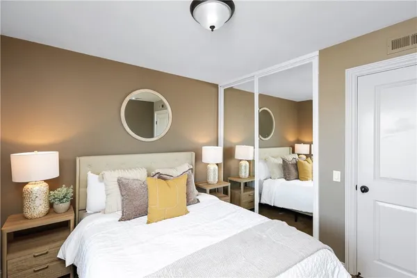 a bedroom with a bed and a lamp