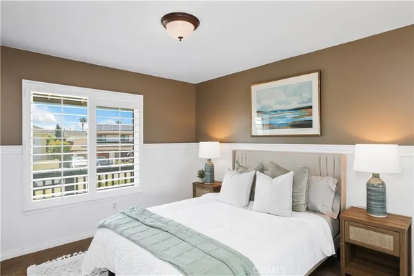 a bedroom with bed and a window