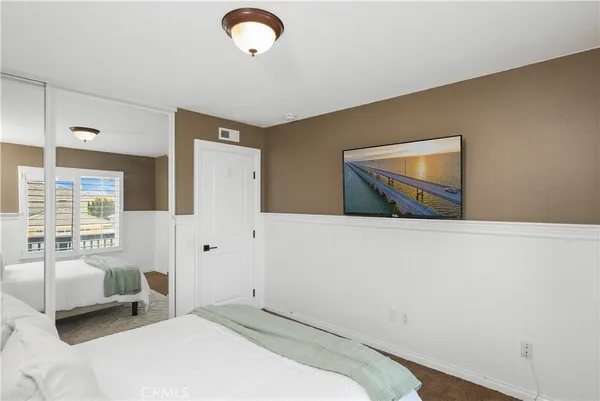 a bedroom with a large bed and a couch