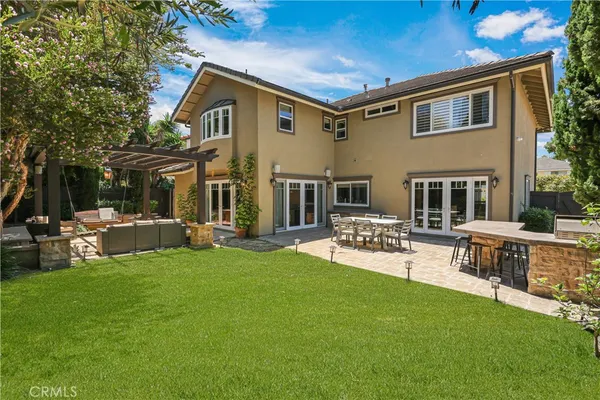 a view of a house with a yard and sitting area