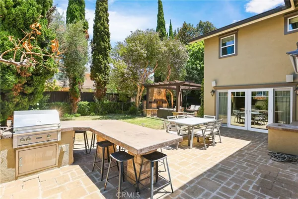 a view of a patio with table and chairs and potted plants