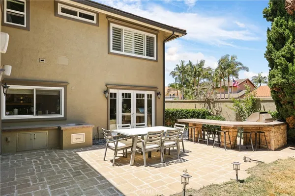 a view of a house with wooden deck and furniture