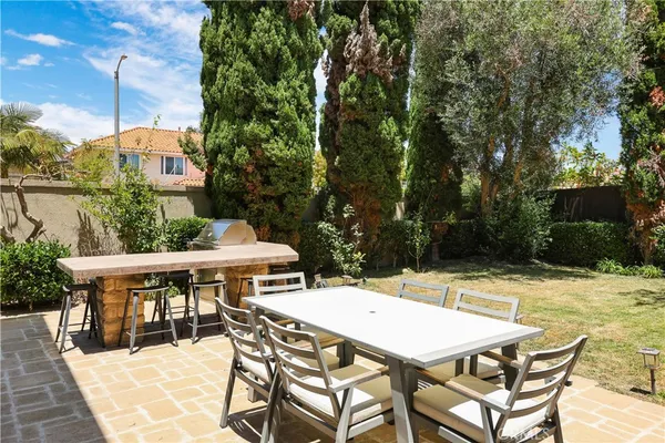 a view of a patio with table and chairs and potted plants