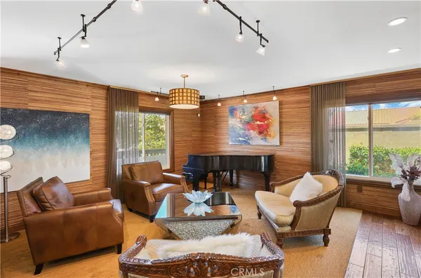 a living room with furniture ceiling fan and a window