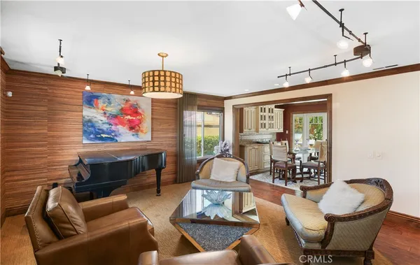 a living room with furniture a rug and a chandelier