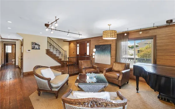 a living room with furniture a rug and a chandelier