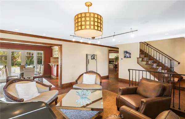a living room with furniture a chandelier and a window