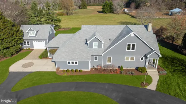 an aerial view of a house with a yard