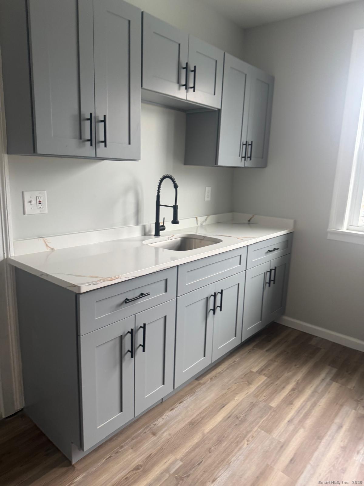 60 Arnold Street Hartford, CT 06106 - Photo 2 of 5 a kitchen with a sink cabinets and wooden floor
