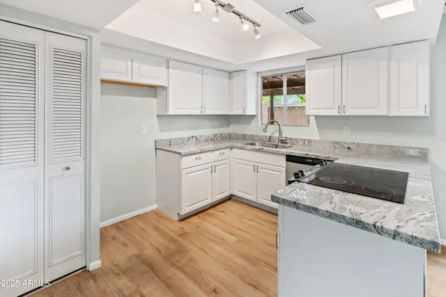 a kitchen with stainless steel appliances granite countertop a stove a sink and a microwave