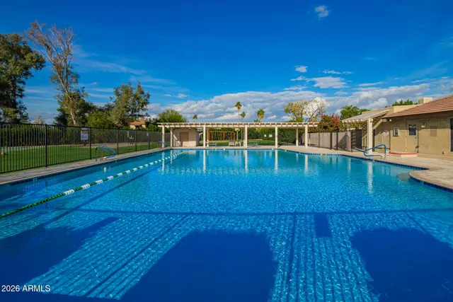 a view of a swimming pool with an outdoor space and seating area