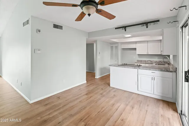 a kitchen with a refrigerator a sink and cabinets