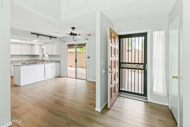 a view of a kitchen with granite countertop a refrigerator and a stove top oven