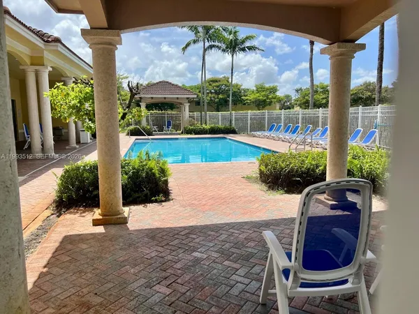 a view of a chairs and table in the patio
