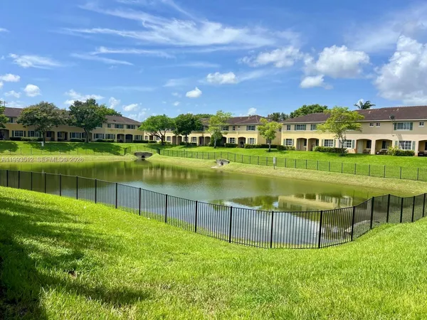 a view of a lake with a house in the background