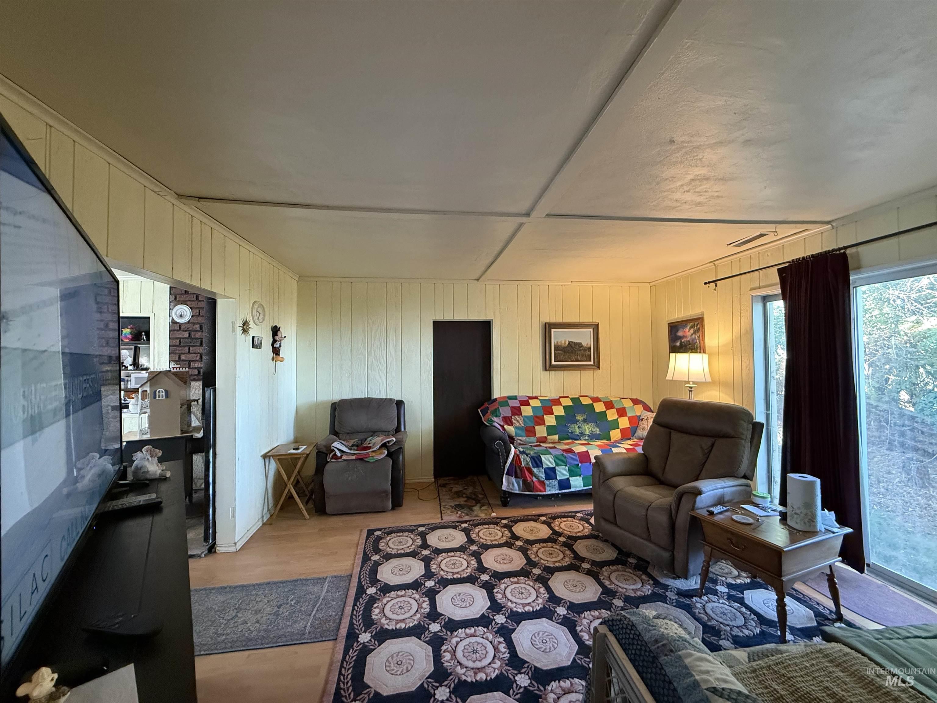 19241 West Homedale Road Caldwell, ID 83607 - Photo 26 of 35 Living area with wooden walls and light wood-style flooring